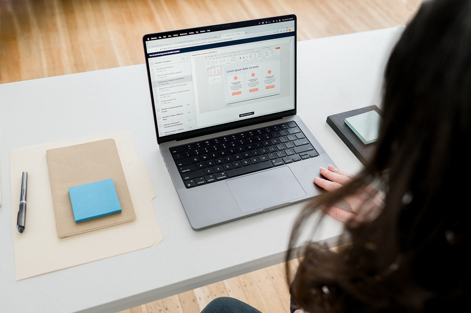 Woman looking at a presentation on the screen of her black laptop